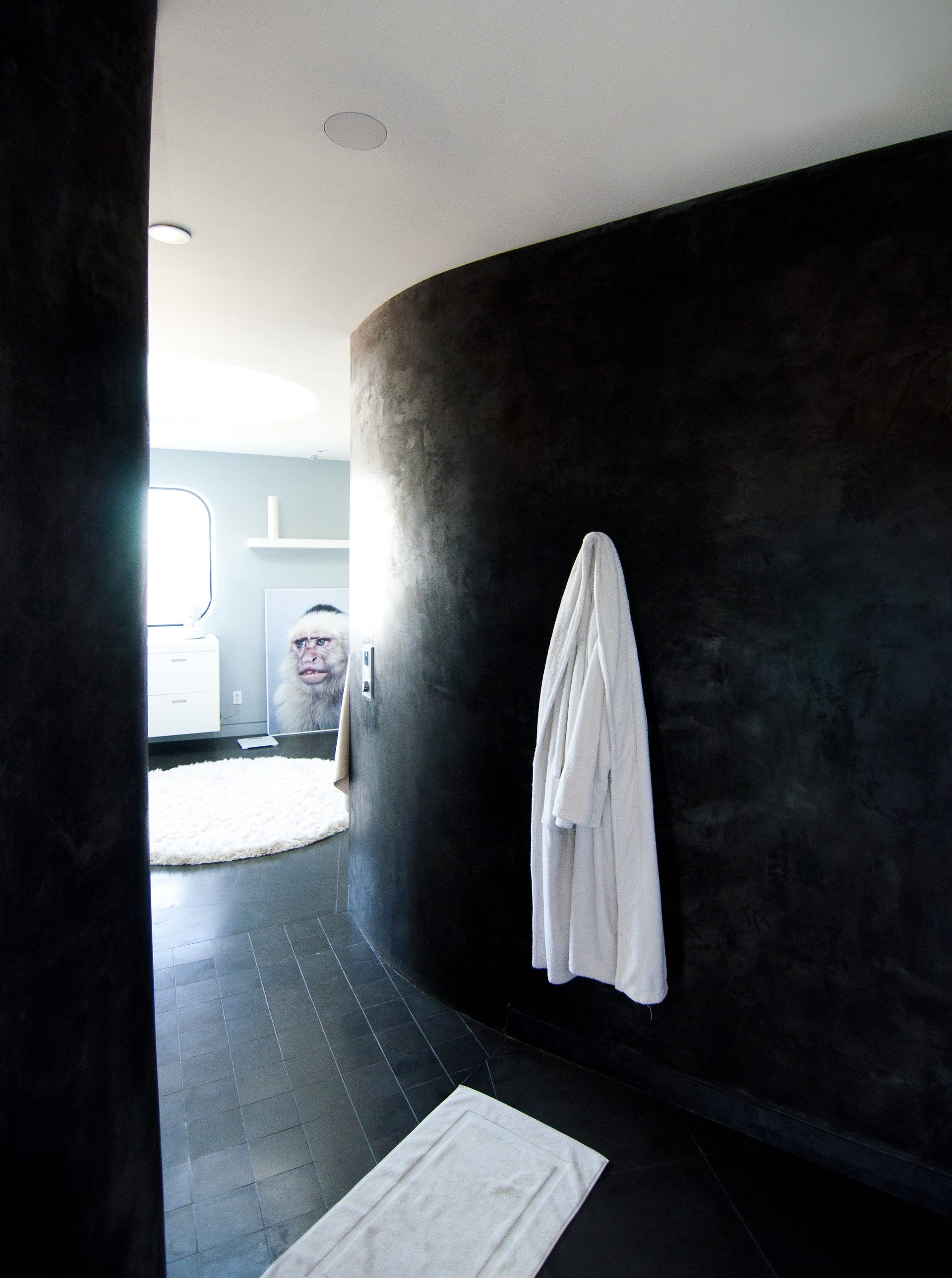 Luxury media room with wood ceiling, in-ceiling speakers and custom built-in entertainment center