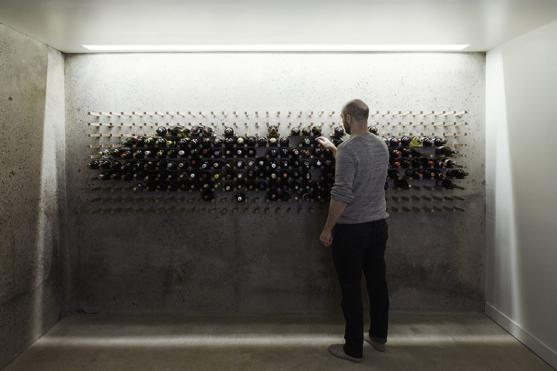 Dramatic dining room with architectural pendant lighting and warm tones